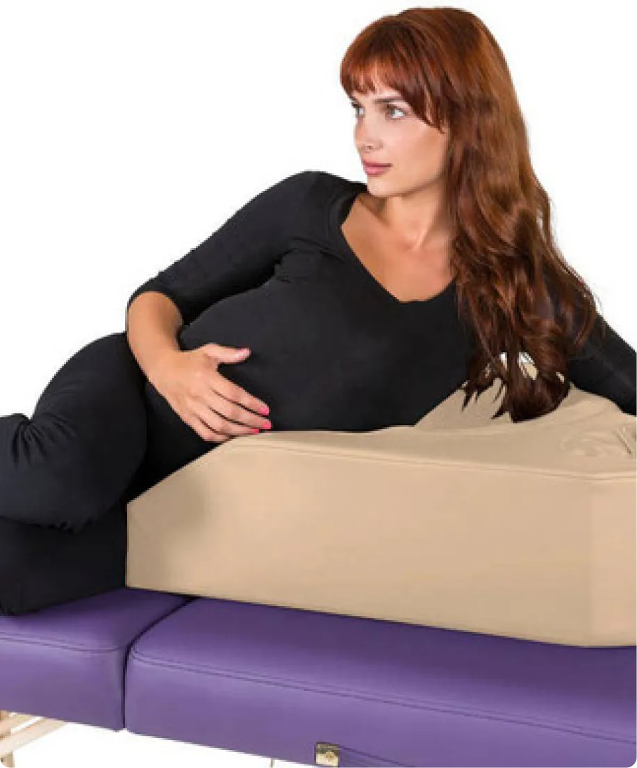 Pregnant person laying on massage table